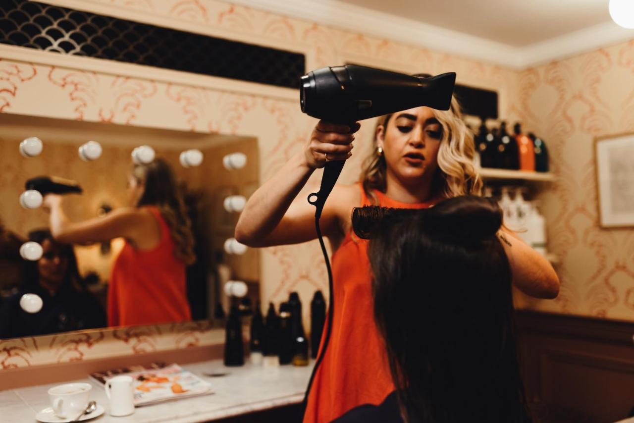 The Ned Hotel London Exterior photo A woman blow-drying her hair
